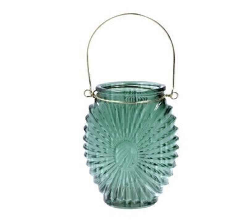This small green glass t-lite holder with a sunburst design is delicate and feminine and would look perfect on a table. Mantle or shelf. Made by London based designer Gisela Graham who designs really beautiful gifts for your home and garden. It fits standard size tealight candles and would make an ideal gift.